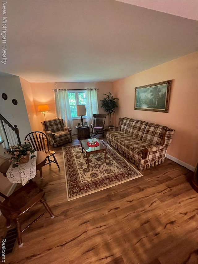 6567 Heaven Dr, Howell, MI 48855 - living area featuring wood finished floors, stairs, and baseboards