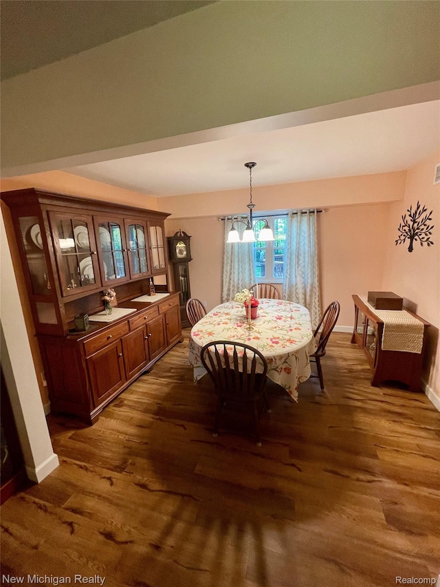 6567 Heaven Dr, Howell, MI 48855 - dining area with dark wood finished floors, baseboards, and a chandelier