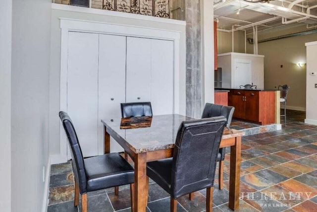 600 NW Broadway Ave Unit 318, Grand Rapids, MI 49504 - dining area with stone tile flooring and baseboards