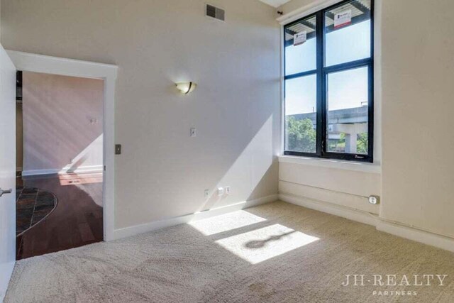 600 NW Broadway Ave Unit 318, Grand Rapids, MI 49504 - spare room featuring carpet flooring and baseboards