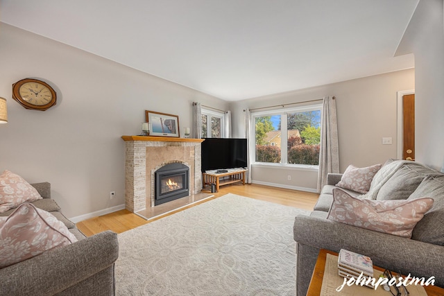 954 Kelsey St NE, Grand Rapids, MI 49505 - living area featuring baseboards, wood finished floors, and a tile fireplace