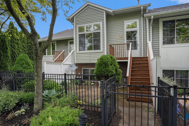 302 NE Xing, Holland, MI 49423 - view of front of home featuring a fenced backyard, stairs, and a gate