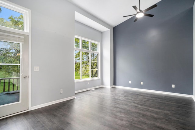 302 NE Xing, Holland, MI 49423 - spare room featuring a ceiling fan, dark wood-type flooring, lofted ceiling, and baseboards