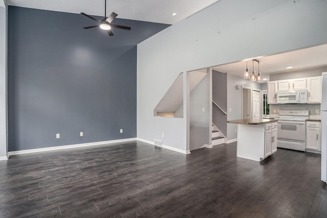 302 NE Xing, Holland, MI 49423 - kitchen featuring white appliances, open floor plan, ceiling fan, dark wood-style floors, and a towering ceiling