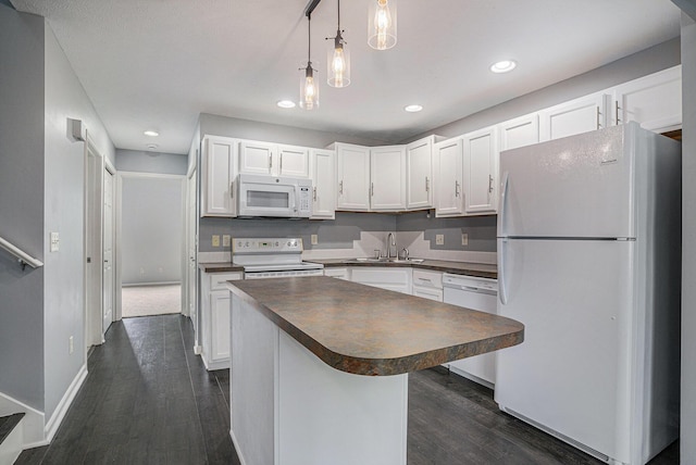 302 NE Xing, Holland, MI 49423 - kitchen with white appliances, dark countertops, a sink, white cabinetry, and recessed lighting