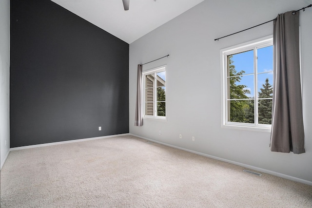 302 NE Xing, Holland, MI 49423 - spare room with a ceiling fan, plenty of natural light, carpet, vaulted ceiling, and baseboards