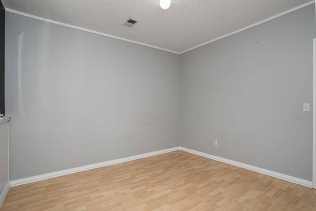 302 NE Xing, Holland, MI 49423 - empty room featuring light wood finished floors, baseboards, and crown molding