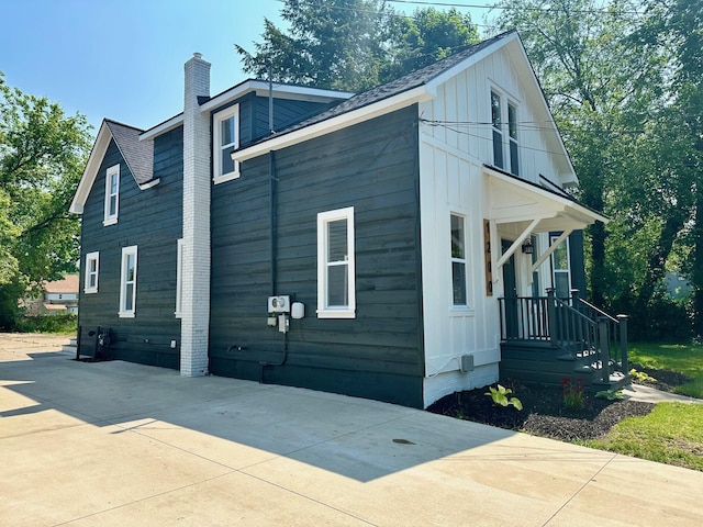 1200 Pine St, Muskegon, MI 49442 - view of property exterior featuring a chimney, board and batten siding, and a shingled roof