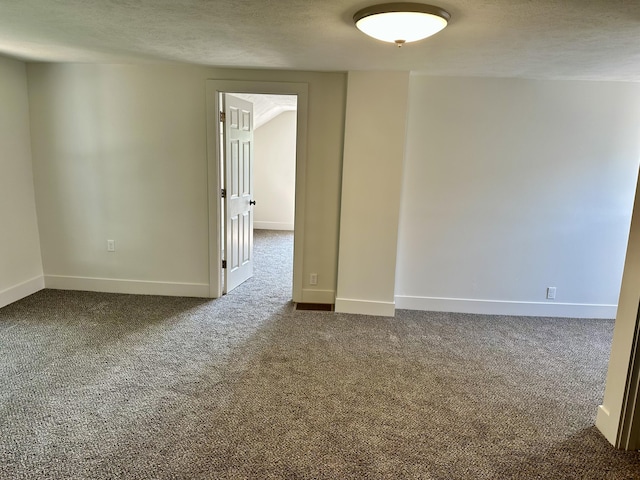 1200 Pine St, Muskegon, MI 49442 - empty room with dark carpet, a textured ceiling, and baseboards
