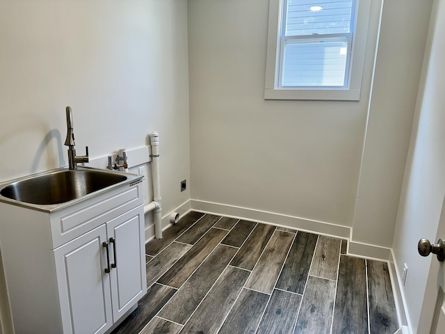 1200 Pine St, Muskegon, MI 49442 - laundry room featuring cabinet space, electric dryer hookup, dark wood-style floors, and baseboards
