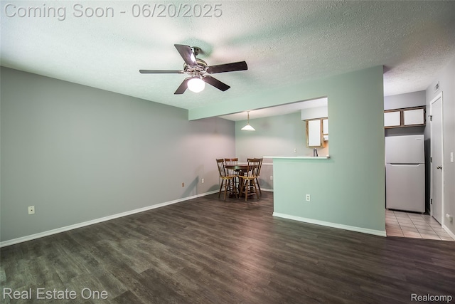 410 Spring Brooke Dr, Brighton, MI 48116 - empty room featuring wood finished floors, ceiling fan, and a textured ceiling
