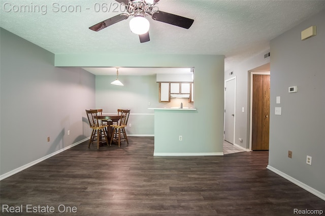 410 Spring Brooke Dr, Brighton, MI 48116 - dining room featuring dark wood-style flooring, a ceiling fan, and a textured ceiling
