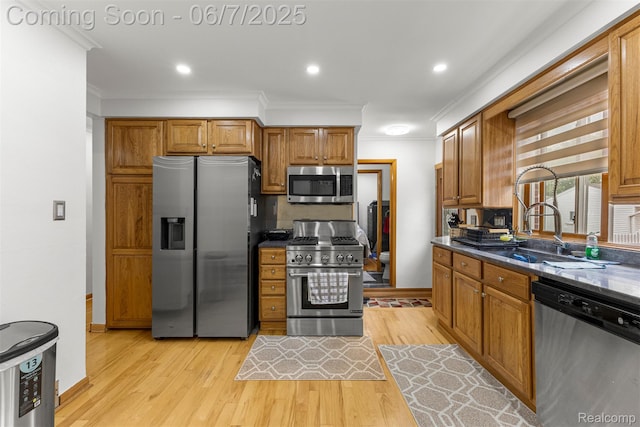 8786 N Evangeline St, Dearborn Heights, MI 48127 - kitchen with stainless steel appliances, light wood finished floors, crown molding, brown cabinets, and baseboards