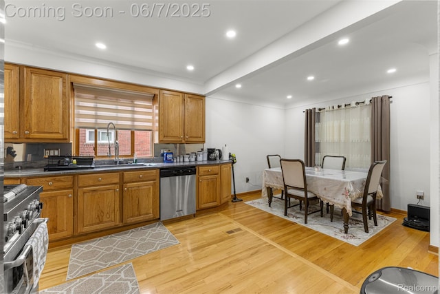 8786 N Evangeline St, Dearborn Heights, MI 48127 - kitchen featuring stainless steel appliances, a sink, brown cabinetry, light wood finished floors, and recessed lighting