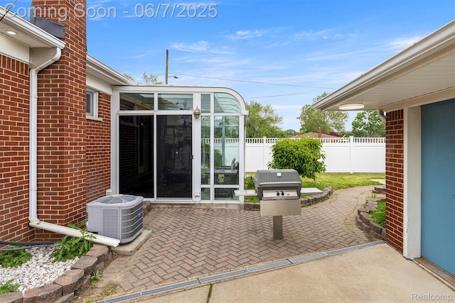 8786 N Evangeline St, Dearborn Heights, MI 48127 - view of patio / terrace featuring central air condition unit and a sunroom