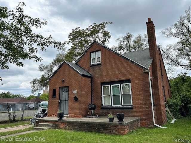 16857 Cheyenne St, Detroit, MI 48235 - view of front of property with brick siding, a chimney, and roof with shingles