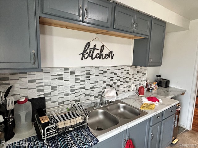 16857 Cheyenne St, Detroit, MI 48235 - kitchen featuring light countertops, gray cabinets, and decorative backsplash