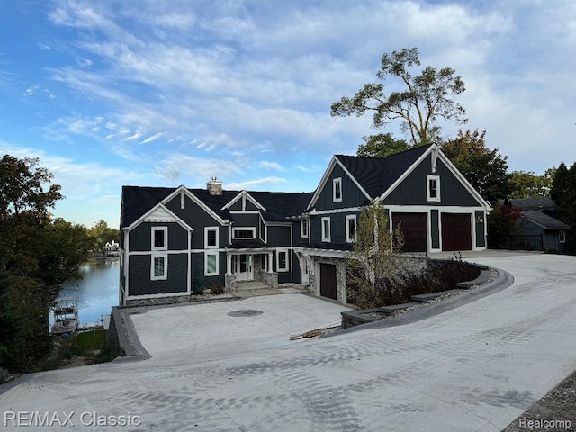 4087 Araby Ct, Highland, MI 48356 - view of front of property with a garage, board and batten siding, and driveway