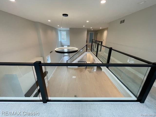 4087 Araby Ct, Highland, MI 48356 - staircase featuring baseboards, recessed lighting, and wood finished floors