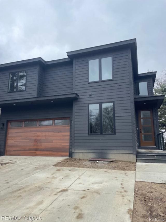 4087 Araby Ct, Highland, MI 48356 - contemporary house with a garage and concrete driveway
