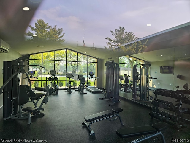 2270 Gulfstream St, Brighton, MI 48114 - exercise room with vaulted ceiling, a wall unit AC, and recessed lighting