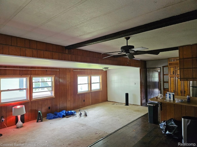 2270 Gulfstream St, Brighton, MI 48114 - kitchen with wood walls, ceiling fan, beamed ceiling, a textured ceiling, and wood finished floors