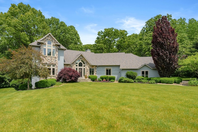 7843 Shepherds Glen Ct, Kalamazoo, MI 49009 - view of front of house with stone siding, a front yard, and a chimney