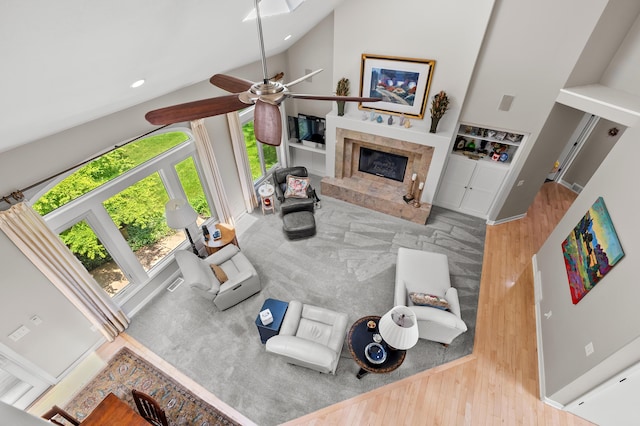 7843 Shepherds Glen Ct, Kalamazoo, MI 49009 - living area with plenty of natural light, wood finished floors, a premium fireplace, ceiling fan, and high vaulted ceiling