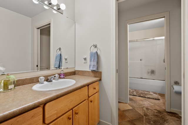 7843 Shepherds Glen Ct, Kalamazoo, MI 49009 - bathroom featuring vanity, stone finish floors, and bath / shower combo with glass door