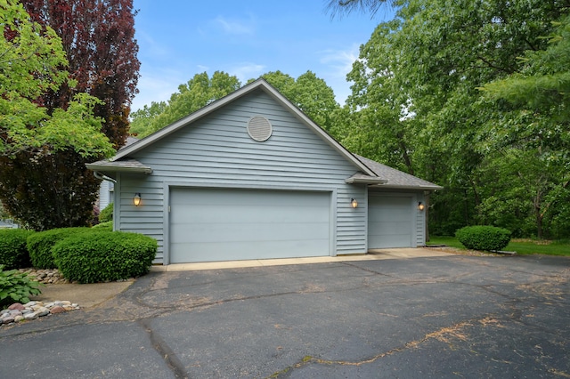 7843 Shepherds Glen Ct, Kalamazoo, MI 49009 - view of front of home with an outbuilding, a garage, and a shingled roof