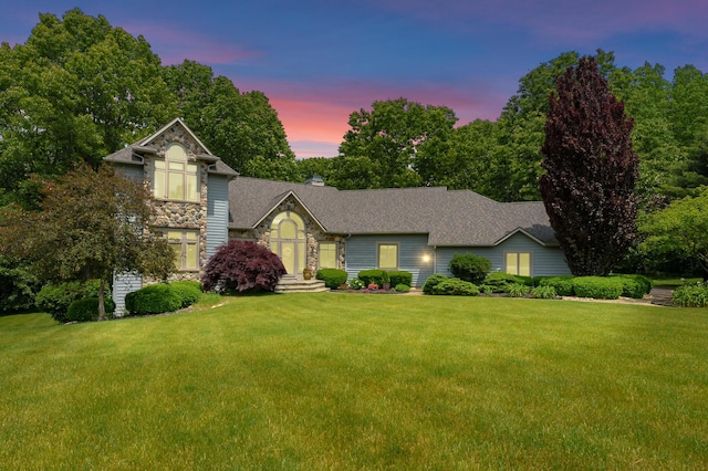 7843 Shepherds Glen Ct, Kalamazoo, MI 49009 - view of front facade featuring a front lawn, stone siding, a shingled roof, and a chimney