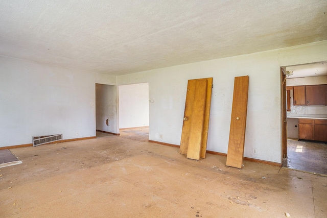 61473 M 40, Paw Paw, MI 49079 - unfurnished bedroom with baseboards and a textured ceiling