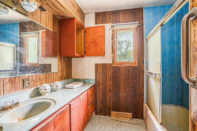 61473 M 40, Paw Paw, MI 49079 - bathroom featuring healthy amount of natural light, vanity, tile patterned floors, and shower / bath combination with glass door