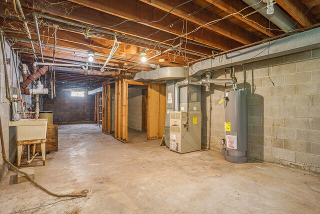 61473 M 40, Paw Paw, MI 49079 - below grade area featuring gas water heater, heating unit, and a sink