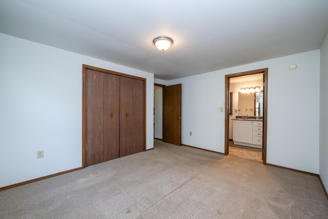 3715 Glen Haven Rd, Saint Joseph, MI 49085 - unfurnished bedroom featuring a closet, baseboards, light colored carpet, and ensuite bath