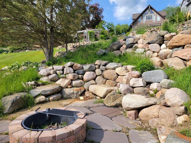 9635 Norman Rd, Clarkston, MI 48348 - exterior view of a fire pit