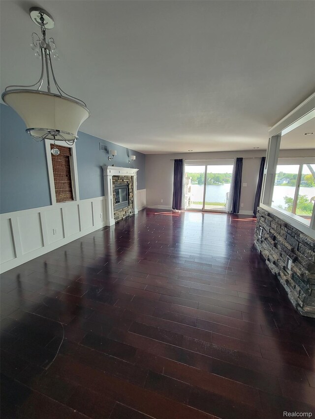 9635 Norman Rd, Clarkston, MI 48348 - living area with a stone fireplace and wood finished floors