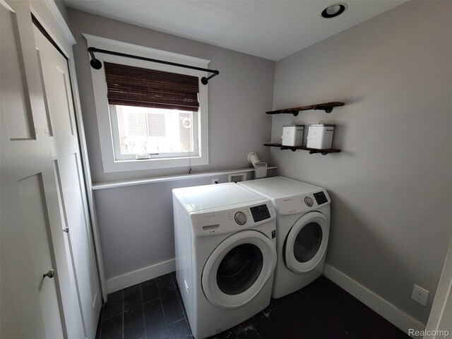 9635 Norman Rd, Clarkston, MI 48348 - washroom featuring washing machine and dryer, baseboards, and dark tile patterned floors