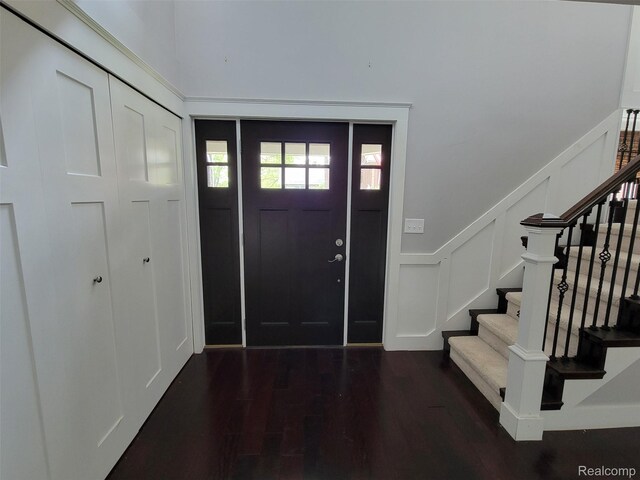 9635 Norman Rd, Clarkston, MI 48348 - foyer with stairway, wood finished floors, and a decorative wall