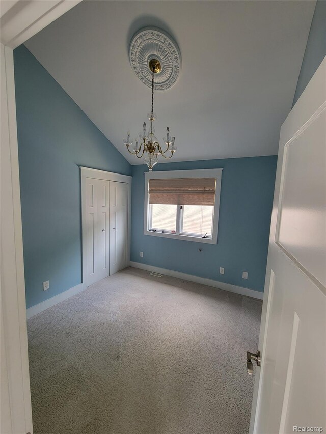 9635 Norman Rd, Clarkston, MI 48348 - unfurnished bedroom featuring lofted ceiling, a chandelier, carpet floors, baseboards, and a closet
