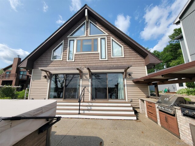 9635 Norman Rd, Clarkston, MI 48348 - back of house featuring an outdoor kitchen, entry steps, and a patio