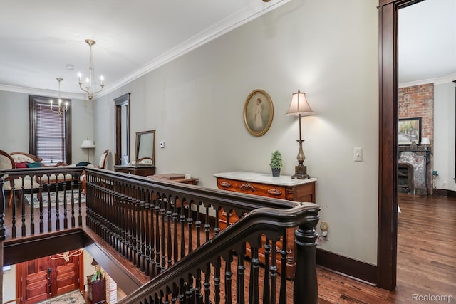 205 Alfred St Unit A, Detroit, MI 48201 - hallway with ornamental molding, a chandelier, wood finished floors, and baseboards
