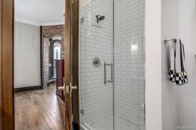 205 Alfred St Unit A, Detroit, MI 48201 - bathroom featuring a stall shower, crown molding, wood finished floors, and baseboards