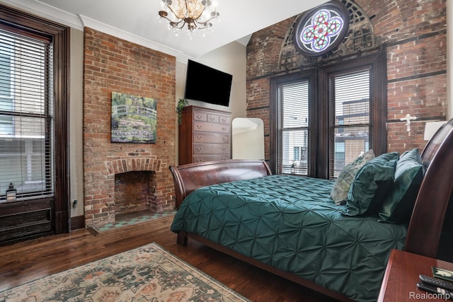 205 Alfred St Unit A, Detroit, MI 48201 - bedroom featuring wood finished floors, a chandelier, lofted ceiling, and a brick fireplace