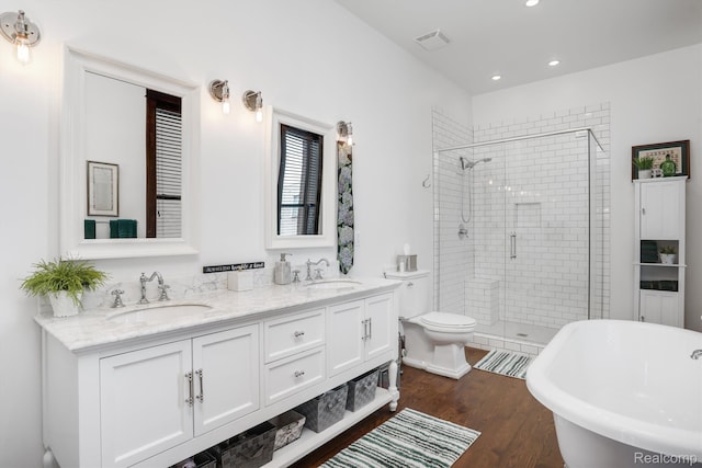 205 Alfred St Unit A, Detroit, MI 48201 - bathroom featuring a shower stall, a freestanding bath, double vanity, wood finished floors, and recessed lighting
