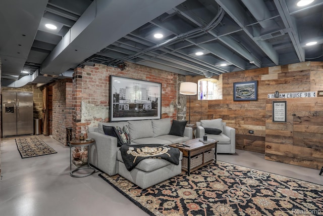 205 Alfred St Unit A, Detroit, MI 48201 - living area with concrete flooring, wood walls, and brick wall