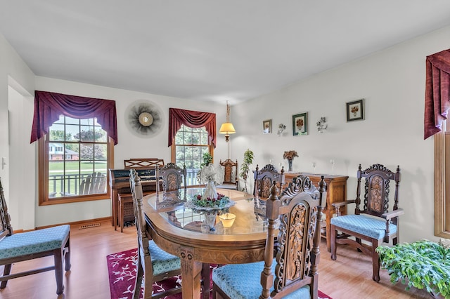 6676 Ralaric Dr, Dexter, MI 48130 - dining space with wood finished floors and baseboards
