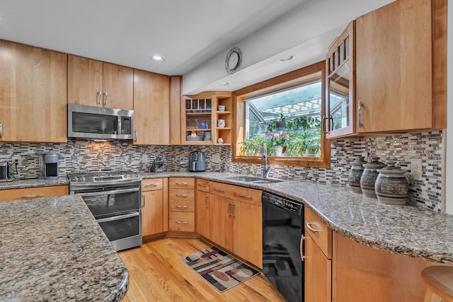 6676 Ralaric Dr, Dexter, MI 48130 - kitchen featuring stainless steel appliances, light stone counters, light wood-style flooring, decorative backsplash, and recessed lighting