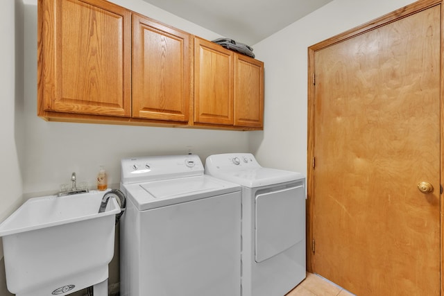 6676 Ralaric Dr, Dexter, MI 48130 - washroom with cabinet space, washing machine and dryer, and light tile patterned floors