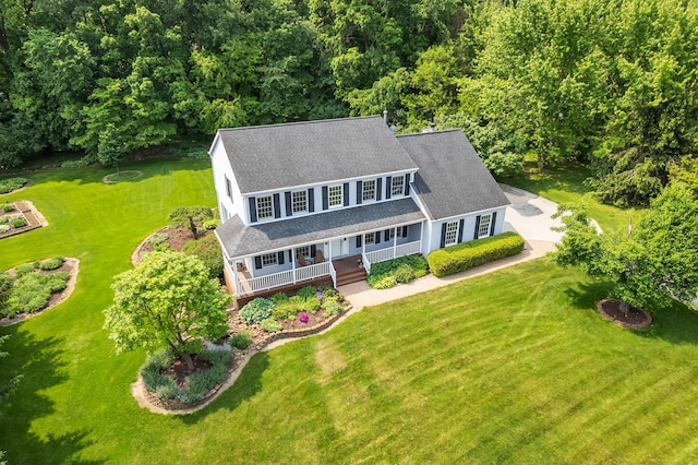 6676 Ralaric Dr, Dexter, MI 48130 - view of front facade with a porch, a shingled roof, and a front yard